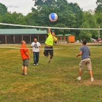 boys playing volleyball with a beach ball