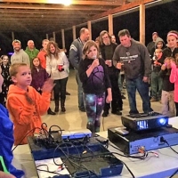 children and adults participating in karaoke