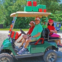People in golf cart decorated with Christmas decorations