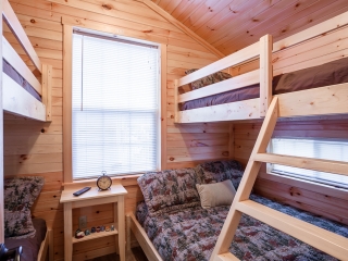 Four Bunk beds and alarm clock in cabin