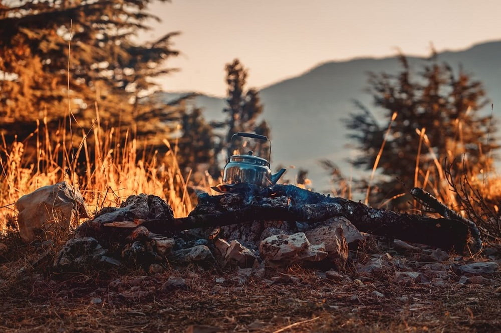 Tea kettle sitting on campfire