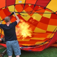 man inflating a hot air balloon