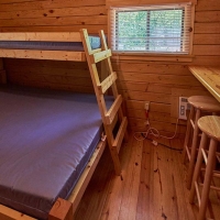 close up of bunk beds with counter and stools