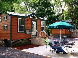 outside of small cabin with people sitting at table