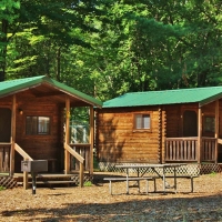 exterior of two cabins with picnic table