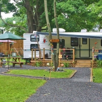 white camper with wooden deck