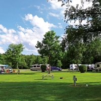 camping resort with campers and picnic table