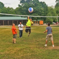 boys playing volleyball with a beach ball
