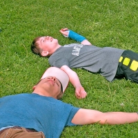 boys resting on grass