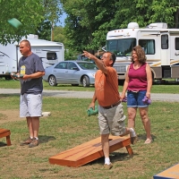 man and woman playing corn hole