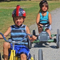 children riding tricycles