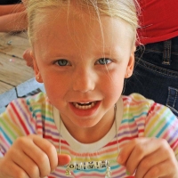 young girl with homemade necklace