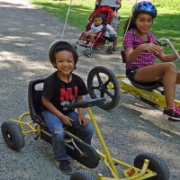 boy and girl riding scooters